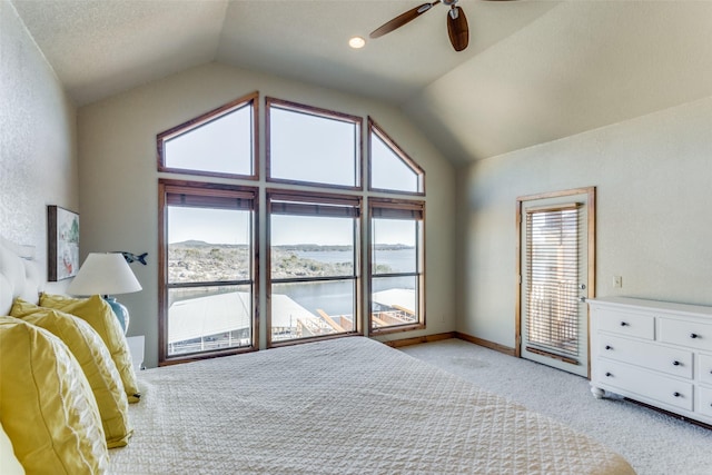 bedroom featuring lofted ceiling, light colored carpet, ceiling fan, and a water view