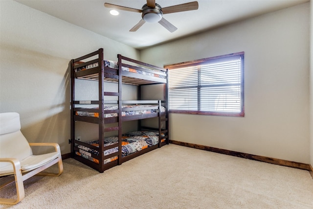 bedroom with ceiling fan and light colored carpet