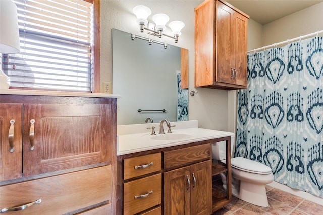 bathroom with toilet, vanity, and a shower with curtain