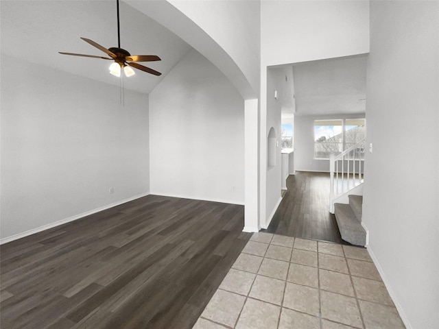 interior space featuring hardwood / wood-style flooring, high vaulted ceiling, and ceiling fan