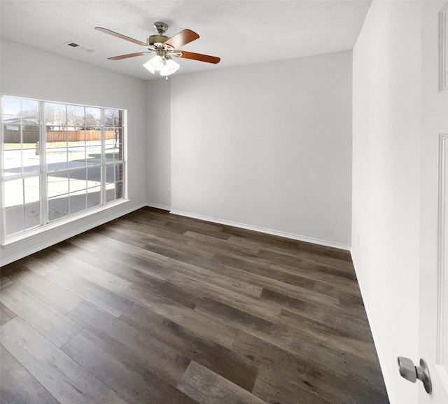 unfurnished room featuring a textured ceiling, dark wood-type flooring, and ceiling fan