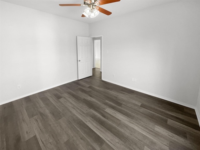 unfurnished room with dark hardwood / wood-style flooring and ceiling fan