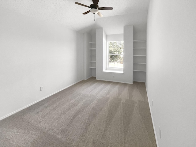 carpeted empty room with a textured ceiling and ceiling fan