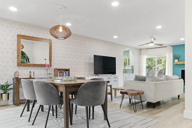 dining area featuring light hardwood / wood-style floors and ceiling fan