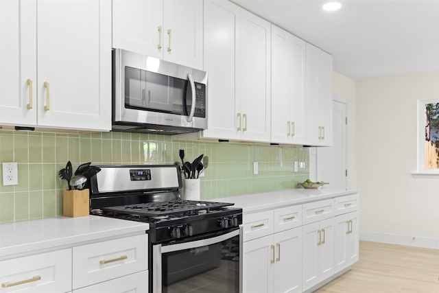 kitchen featuring light hardwood / wood-style floors, white cabinetry, backsplash, and appliances with stainless steel finishes