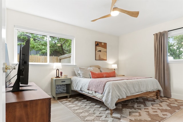 bedroom with ceiling fan and light hardwood / wood-style floors