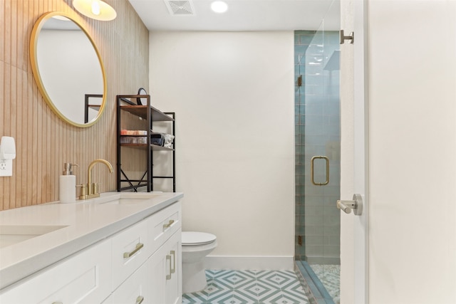 bathroom featuring an enclosed shower, vanity, and toilet