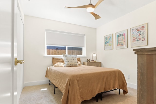 bedroom with ceiling fan and light carpet