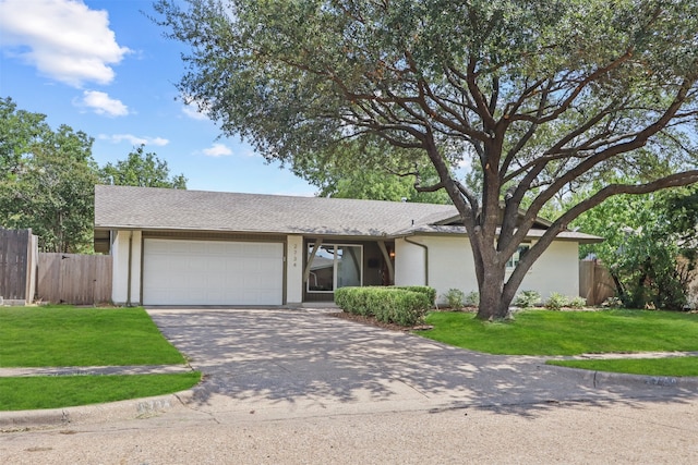 ranch-style home featuring a front lawn and a garage