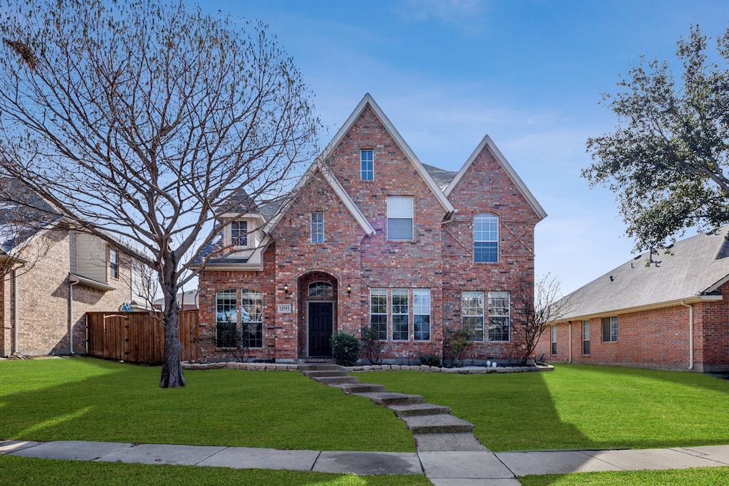 tudor home featuring a front lawn