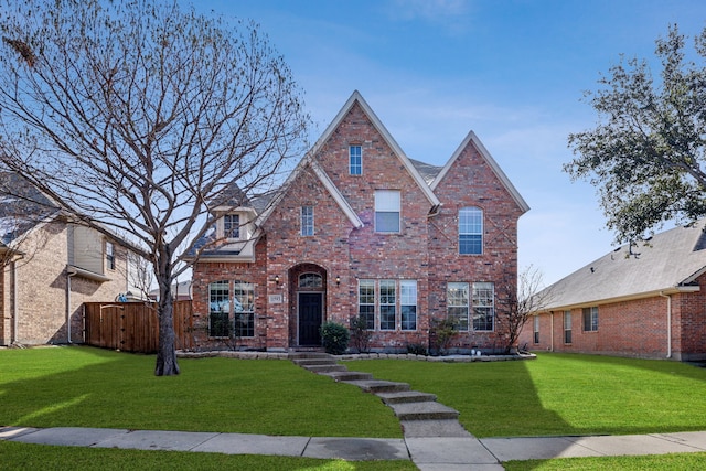 tudor home featuring a front lawn