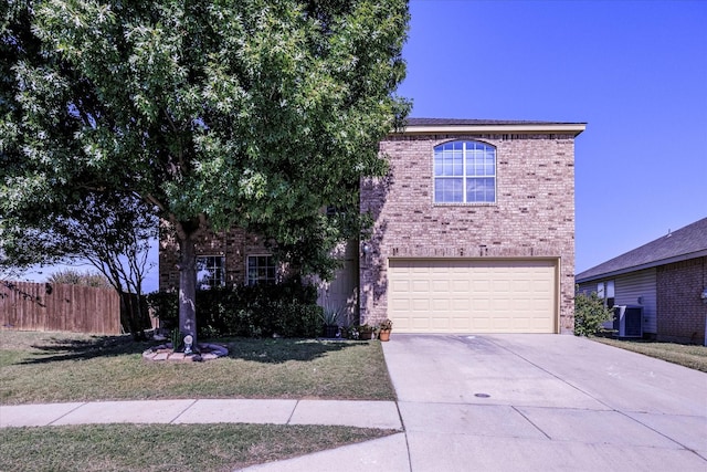 view of front of home featuring a front yard, a garage, and central AC unit