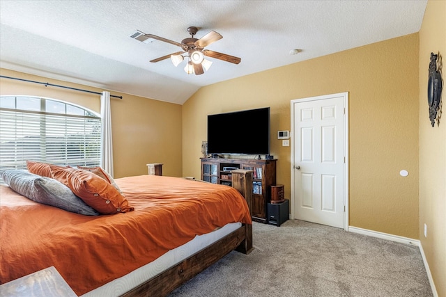 bedroom featuring a textured ceiling, ceiling fan, vaulted ceiling, and light colored carpet