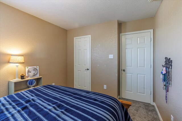 carpeted bedroom featuring a textured ceiling