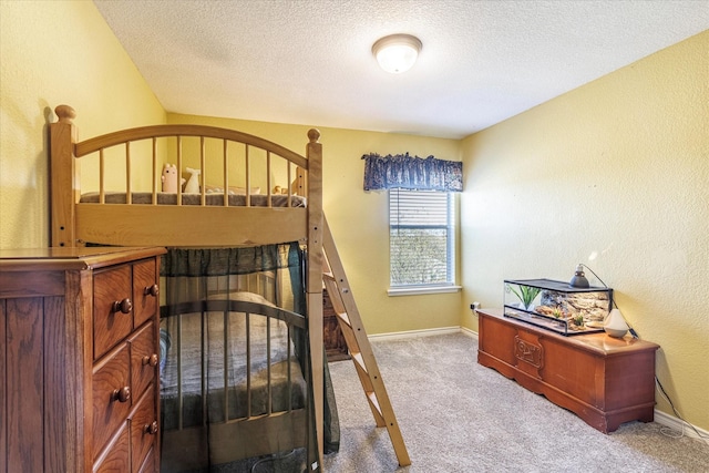 carpeted bedroom featuring a textured ceiling