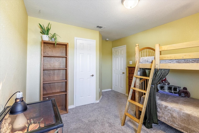 carpeted bedroom with a textured ceiling