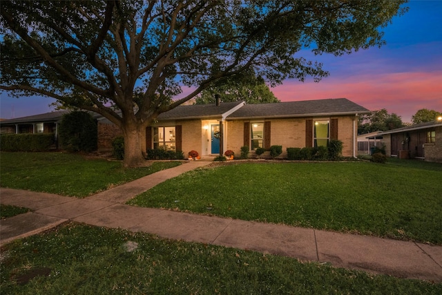 ranch-style house featuring a lawn