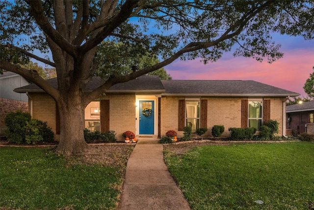 ranch-style house featuring a lawn