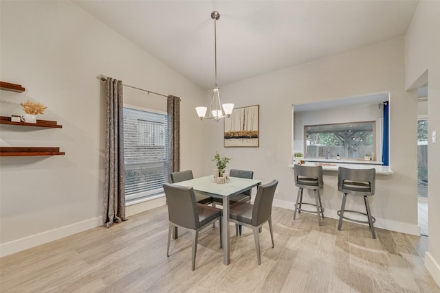 dining area with lofted ceiling, light hardwood / wood-style floors, and a healthy amount of sunlight