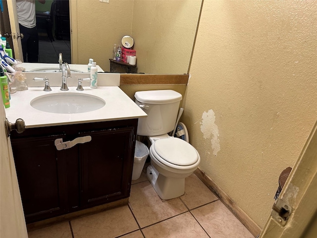 bathroom featuring tile patterned flooring, vanity, and toilet