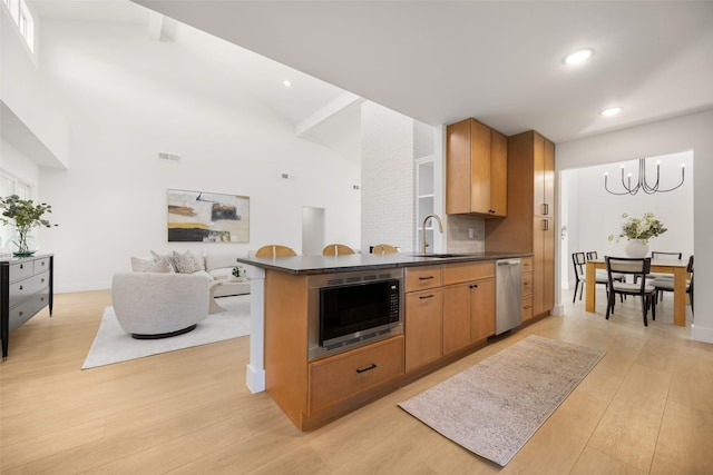 kitchen featuring light hardwood / wood-style flooring, built in microwave, sink, backsplash, and beam ceiling