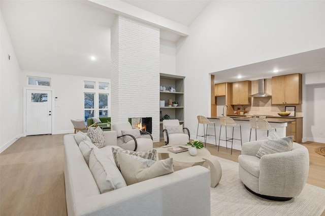 living room featuring a notable chandelier, a healthy amount of sunlight, hardwood / wood-style floors, and lofted ceiling