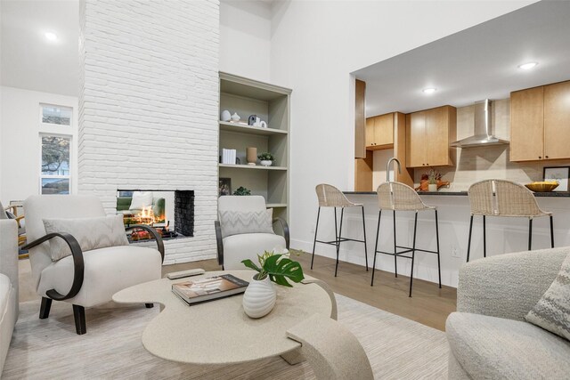 sitting room with light hardwood / wood-style floors and a fireplace