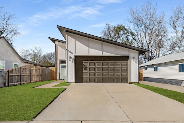 exterior space featuring a front lawn, a garage, and an outdoor structure