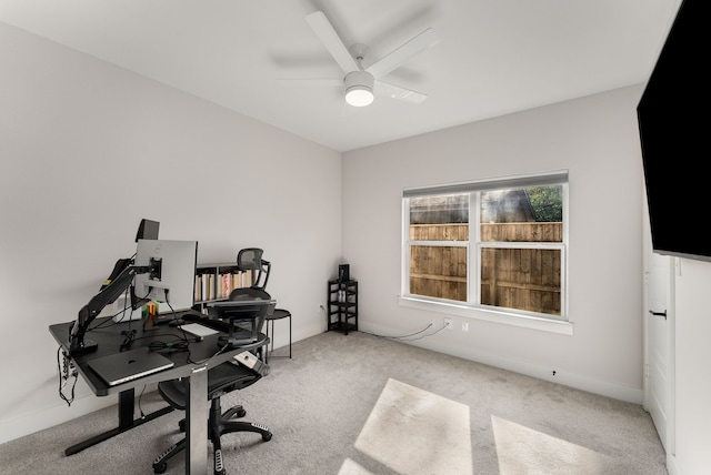 carpeted home office with ceiling fan