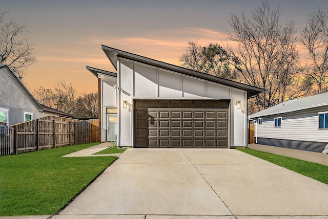 view of front of house with a yard and a garage