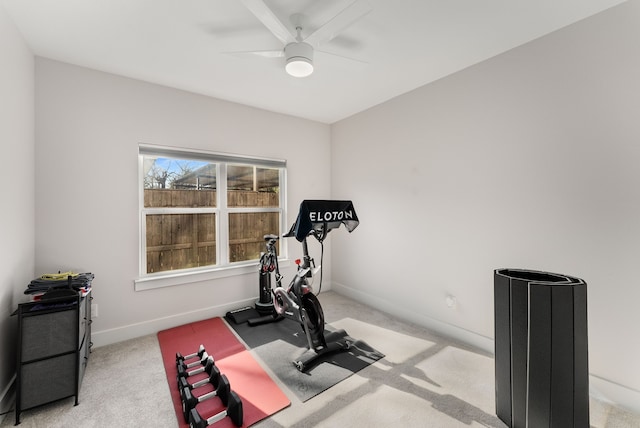 workout room featuring ceiling fan and light colored carpet