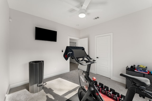 workout room with light carpet and ceiling fan