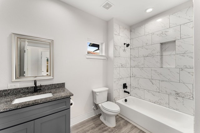 full bathroom featuring vanity, toilet, tiled shower / bath combo, and hardwood / wood-style flooring