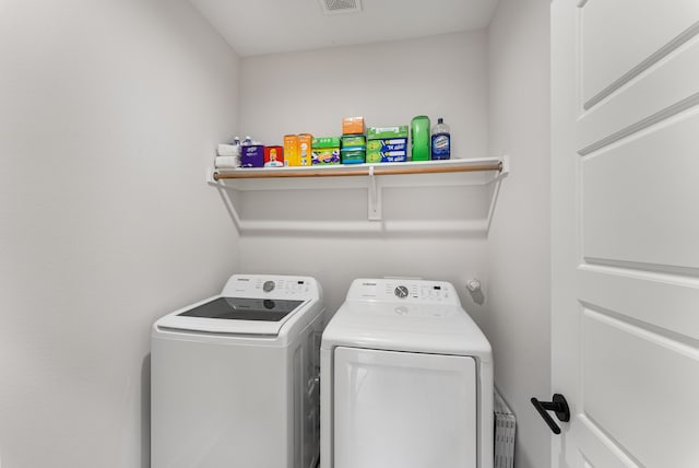 clothes washing area with separate washer and dryer