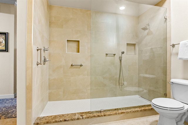 bathroom featuring toilet and tiled shower