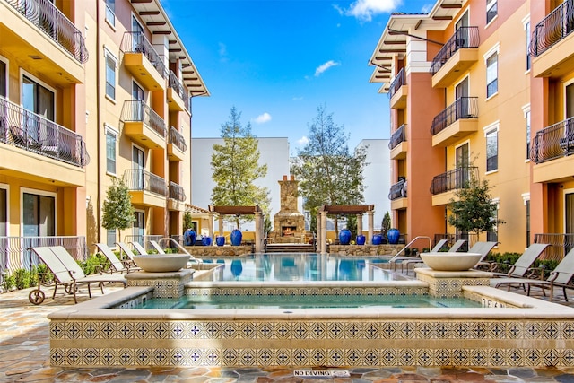 view of pool with a hot tub