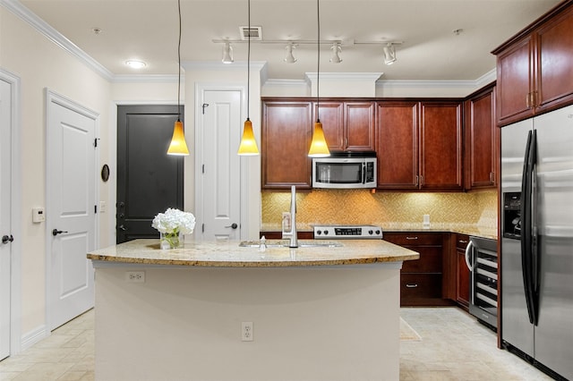 kitchen with stainless steel appliances, an island with sink, hanging light fixtures, light stone counters, and tasteful backsplash