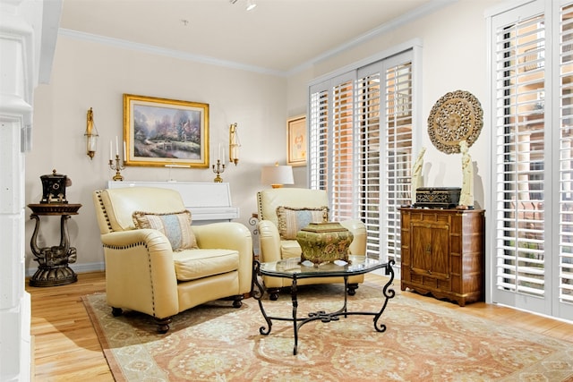 sitting room featuring ornamental molding and wood-type flooring