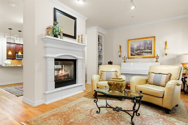 living area featuring a multi sided fireplace, wood-type flooring, ornamental molding, and built in features