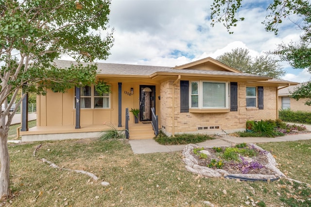 ranch-style house with covered porch and a front lawn