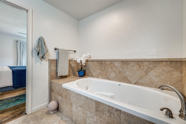 bathroom featuring tiled tub and tile patterned floors