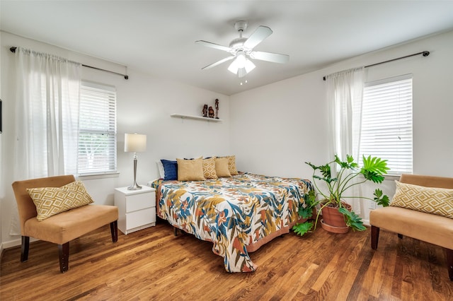 bedroom with ceiling fan and wood-type flooring