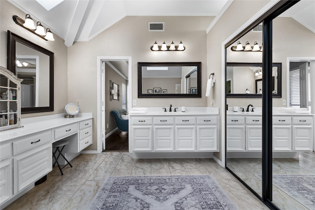 bathroom featuring lofted ceiling and vanity