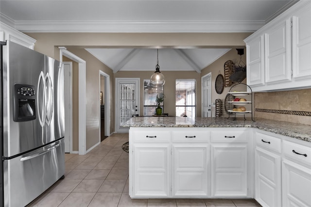 kitchen featuring light stone counters, stainless steel refrigerator with ice dispenser, white cabinetry, lofted ceiling, and tasteful backsplash