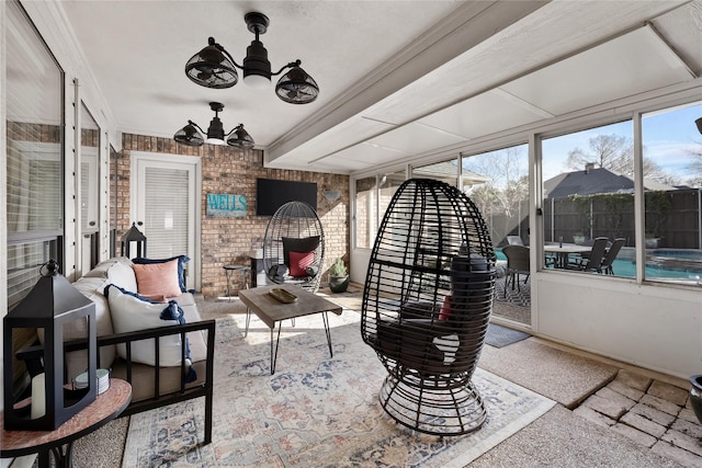 sunroom / solarium featuring ceiling fan