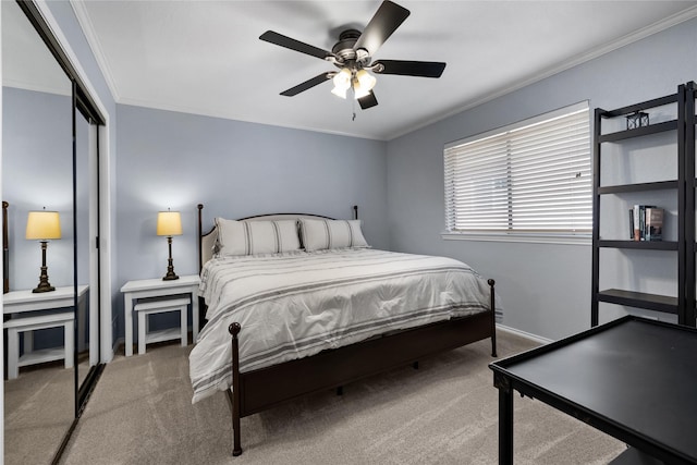 carpeted bedroom featuring a closet, ceiling fan, and ornamental molding