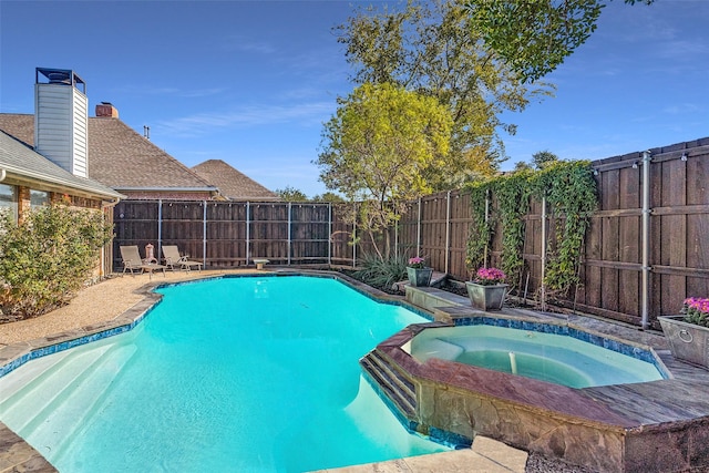 view of swimming pool featuring an in ground hot tub