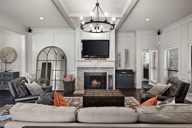 living room with beam ceiling, dark hardwood / wood-style flooring, crown molding, and a chandelier