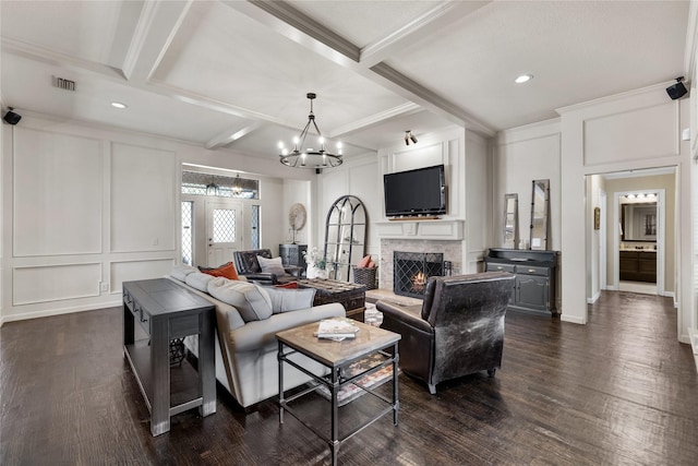 living room with a premium fireplace, dark hardwood / wood-style flooring, coffered ceiling, and beamed ceiling