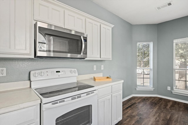 kitchen with white range with electric cooktop, white cabinetry, and dark hardwood / wood-style floors